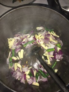 Now add onion, green chilies and garlic.