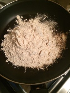 Add atta in a heated pan.