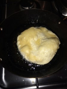 Drop the poori in the oil.