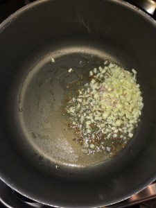 Let the cumin splutter. Add finely chopped garlic.