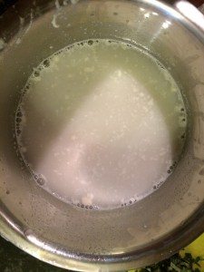 Wash the grinder with a cup of water and remove the water to a small bowl.