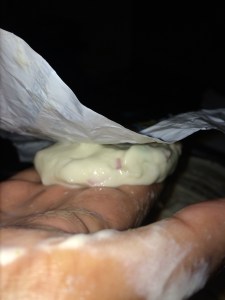 Again after making your hand wet with the water transfer the vada from the sheet to the right hand tip.