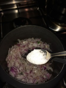 Add salt and saute the onion.