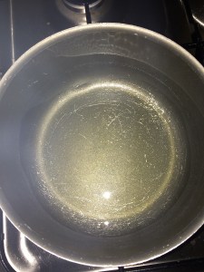 Take oil in a vessel.