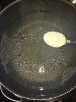 Add little sugar to the boiling water. This helps to retain the color of the spinach.