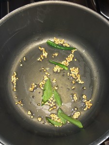 Temper mustard and urad dal along with curry leaves.