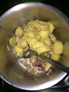 After the onion and garlic gets cooked add the chopped Yam/Karunai Kilangu and sautee for a while.