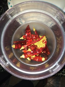 Take the red chilies and methi seeds in a blender and grind it until you get a coarse powder.