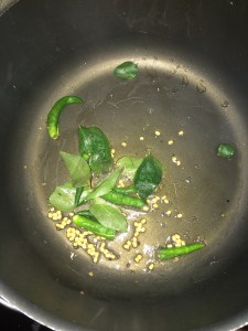 Add curry leaves and slit green chilies.