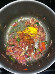 After the toamtoes get mushy add the chili powder and turmeric.