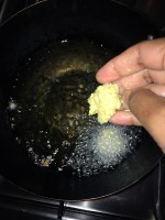 take small amount of the vada mixture and drop it into the oil.
