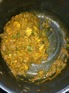 Chicken curry is ready to be served with rice.