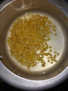 Take toor dal in pressure cooker with some water.