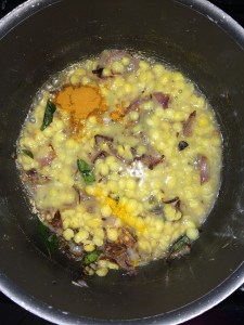 Add the cooked toor dal , turmeric and sambar powder.