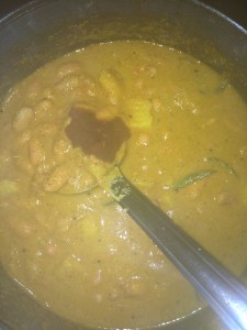 Open the pressure cooker and add tamarind paste.