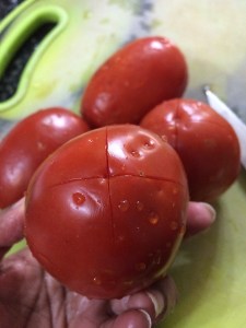 Make a cross mark using a knife on every tomato.