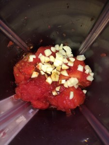 Rough chop the tomatoes and put them in a blender along with chopped garlic.
