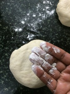 Sprinkle flour on the flour and your hands and spread the dough using your fingers.