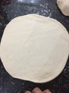 Use a rolling pin to get the desired thin crust.