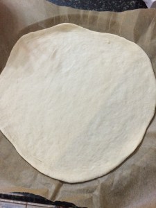 Roll out the pizza dough as thin as possible.