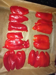 Arrange all the capsicum's in a tray on top of the parchment paper.