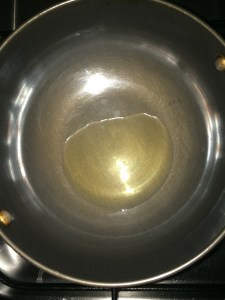 Take oil in a vessel.