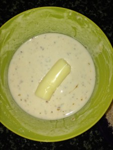 Now dip the mozarella stick first into the flour mixture, coating completely.