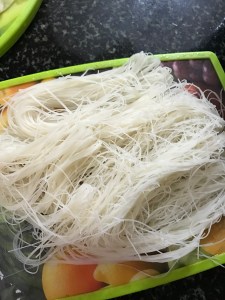 Drain the Mee Hoon/Rice Vermicelli from the water and place it on a cutting board.